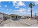 Single story home featuring covered parking, desert landscaping, and mature palm tree at 429 N 10Th St, Las Vegas, NV 89101
