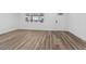 Spacious living room featuring light hardwood floors, white walls and a bright entry door at 429 N 10Th St, Las Vegas, NV 89101
