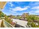 Scenic balcony view showcasing lush greenery, covered parking, and a clear blue sky with scattered clouds at 4809 S Torrey Pines Dr # 201, Las Vegas, NV 89103