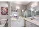 Bathroom featuring dual sinks, a large mirror, and toilet at 4809 S Torrey Pines Dr # 201, Las Vegas, NV 89103