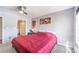 Cozy bedroom with grey walls, red bedspread, and art on the walls at 4809 S Torrey Pines Dr # 201, Las Vegas, NV 89103