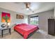 Cozy bedroom featuring soft carpet, ceiling fan, and vibrant modern art at 4809 S Torrey Pines Dr # 201, Las Vegas, NV 89103