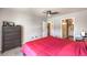 Neutral toned bedroom featuring a bed with a red bedspread and furniture at 4809 S Torrey Pines Dr # 201, Las Vegas, NV 89103