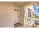 Welcoming front door with 'Welcome' mat, unit number, and a view of the building's exterior from the porch at 4809 S Torrey Pines Dr # 201, Las Vegas, NV 89103