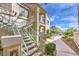 Inviting two-story building with well-maintained landscaping and a charming outdoor staircase under a bright blue sky at 4809 S Torrey Pines Dr # 201, Las Vegas, NV 89103