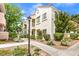 Condominium complex featuring beige stucco, red tile roof, and green landscaping at 4809 S Torrey Pines Dr # 201, Las Vegas, NV 89103