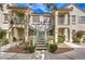 Condominium building featuring exterior staircase, stucco and landscaping at 4809 S Torrey Pines Dr # 201, Las Vegas, NV 89103