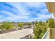 Apartment view of parking, trees, and a blue sky with some clouds at 4809 S Torrey Pines Dr # 201, Las Vegas, NV 89103