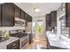 Charming kitchen with stainless steel appliances, dark cabinetry, and ample natural light at 4809 S Torrey Pines Dr # 201, Las Vegas, NV 89103