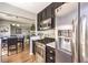 Modern kitchen with stainless steel appliances, dark cabinets, and an open layout to the dining area at 4809 S Torrey Pines Dr # 201, Las Vegas, NV 89103