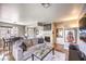 Spacious living room with a stone fireplace, comfortable seating, and an open layout to the dining area at 4809 S Torrey Pines Dr # 201, Las Vegas, NV 89103