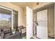 Outdoor patio space with a sliding glass door, washer/dryer, and cozy seating area at 4809 S Torrey Pines Dr # 201, Las Vegas, NV 89103