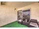 Cozy outdoor patio featuring comfortable seating, artificial turf, and a sliding glass door leading inside at 4809 S Torrey Pines Dr # 201, Las Vegas, NV 89103
