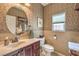 Charming powder room with decorative wallpaper, a vanity, and a stylish oval mirror at 5005 Justice Creek Ave, Las Vegas, NV 89131