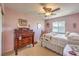 Bedroom featuring an antique dresser, ceiling fan, and light pink walls at 5005 Justice Creek Ave, Las Vegas, NV 89131