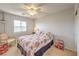 Bright bedroom with floral bedding, ceiling fan and view of the mountains at 5005 Justice Creek Ave, Las Vegas, NV 89131