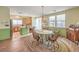 Bright dining area with wooden table and chairs, next to the kitchen with stainless steel appliances at 5005 Justice Creek Ave, Las Vegas, NV 89131