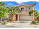 Attractive two-story house showcasing a tidy front yard with a two-car garage and vibrant, healthy trees at 5005 Justice Creek Ave, Las Vegas, NV 89131