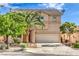 Charming two-story home featuring a well-maintained front yard and attached two-car garage at 5005 Justice Creek Ave, Las Vegas, NV 89131