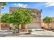 Inviting two-story house with lush landscaping, a well-manicured lawn, and a convenient two-car garage at 5005 Justice Creek Ave, Las Vegas, NV 89131