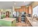 Well-equipped kitchen features stainless steel appliances, tile flooring, and a functional center island at 5005 Justice Creek Ave, Las Vegas, NV 89131