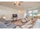 Inviting living room with a comfortable sofa and chairs, and views of the entry and adjacent dining area at 5005 Justice Creek Ave, Las Vegas, NV 89131