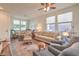 Cozy living room featuring comfortable seating, a decorative rug, and natural light from large windows at 5005 Justice Creek Ave, Las Vegas, NV 89131