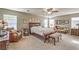Spacious main bedroom boasts comfortable furnishings, a ceiling fan, and abundant natural light at 5005 Justice Creek Ave, Las Vegas, NV 89131