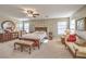Generously sized main bedroom with a ceiling fan, ample natural light, and elegant decor at 5005 Justice Creek Ave, Las Vegas, NV 89131