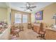 Bright home office with natural light, ceiling fan, and a variety of furniture for work and leisure at 5005 Justice Creek Ave, Las Vegas, NV 89131
