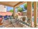 Inviting covered patio with comfortable seating overlooking a pool and outdoor fireplace, perfect for gatherings at 5005 Justice Creek Ave, Las Vegas, NV 89131