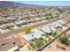An aerial view displaying the home, backyard with patio, and surrounding neighborhood in a residential community at 525 Engel Ave, Henderson, NV 89011