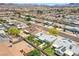 An aerial view of the community showcasing the home, fenced backyard, and neighborhood with various roof types at 525 Engel Ave, Henderson, NV 89011