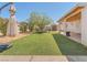 Spacious backyard with artificial grass, a covered patio, and a storage shed at 525 Engel Ave, Henderson, NV 89011