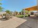 Spacious backyard with covered patio, a dining set, and a shed in the far corner at 525 Engel Ave, Henderson, NV 89011