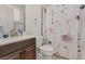 Bathroom featuring a modern sink, toilet, and shower with a floral curtain at 525 Engel Ave, Henderson, NV 89011