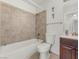 Bathroom with a tiled shower and tub combination, toilet, and a vanity sink at 525 Engel Ave, Henderson, NV 89011