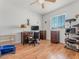Cozy bedroom with hardwood floors, a window with blinds, and neutral-colored walls at 525 Engel Ave, Henderson, NV 89011