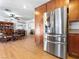 Modern kitchen with stainless steel appliances and wood floors, next to a dining area at 525 Engel Ave, Henderson, NV 89011
