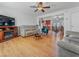 Open-concept living room featuring hardwood floors, ceiling fan, and plenty of natural light at 525 Engel Ave, Henderson, NV 89011