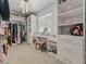 Spacious walk-in closet featuring custom shelving, cabinets, and dressing area at 525 Engel Ave, Henderson, NV 89011