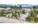 Aerial view of home showcasing circular driveway, mature landscaping, and lush palm trees at 5890 W Patrick Ln, Las Vegas, NV 89118