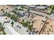 Aerial view of desert home and lot featuring an adjacent vacant lot with beautiful palm trees at 5890 W Patrick Ln, Las Vegas, NV 89118