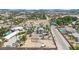 Aerial view of desert home and lot featuring an adjacent vacant lot with beautiful palm trees at 5890 W Patrick Ln, Las Vegas, NV 89118