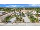 An aerial view of a home featuring a circular driveway, mature landscaping, and palm trees at 5890 W Patrick Ln, Las Vegas, NV 89118