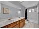 Bathroom view with double vanity, framed artwork, and combined shower and tub at 5890 W Patrick Ln, Las Vegas, NV 89118