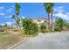 Two story home features mature landscaping and a circular driveway at 5890 W Patrick Ln, Las Vegas, NV 89118