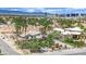 Expansive single-story homes nestled among lush palm trees and landscaping with a beautiful Las Vegas cityscape view at 5890 W Patrick Ln, Las Vegas, NV 89118