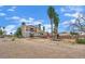 The home's exterior features a two-story design, a large yard, a balcony, and tall palm trees at 5890 W Patrick Ln, Las Vegas, NV 89118