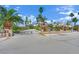 Spacious property with a secured fence, mature landscaping and multiple palm trees at 5890 W Patrick Ln, Las Vegas, NV 89118